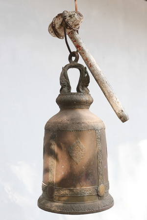 Old bell on white wall.の写真素材