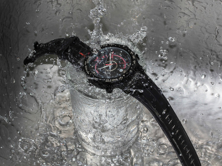 Pour water into the wristwatch - Waterproof wristwatch concept.の写真素材