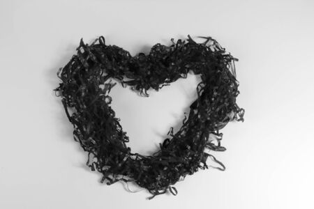 Black paper hearts on grey background - Grain Concept.の写真素材