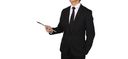 Businessmen hold a touch screen tablet in the city at night to work for success. confidence conection concept.の写真素材