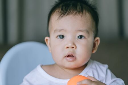 Infants are playing ball happily inside the house - Art tone concept.の写真素材