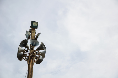 Many loudspeakers against cloudy blue skyの写真素材
