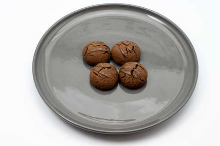 Delicious, homemade chocolate-covered brown cookies on a plate. Photos with an isolated white background.の写真素材