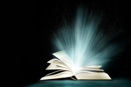 Opened magic book with magic light の写真素材