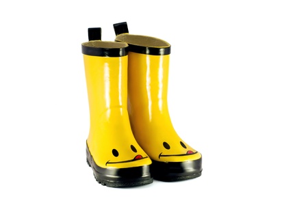 Yellow children`s boots isolated on whiteの写真素材