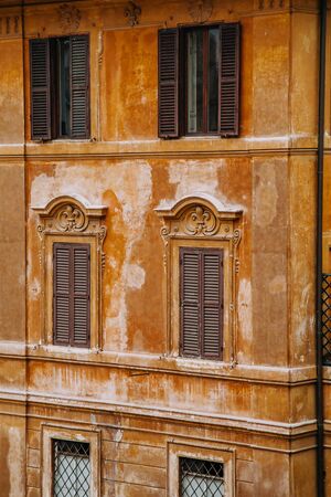 European windows with wooden shutters. Old house exterior.の写真素材