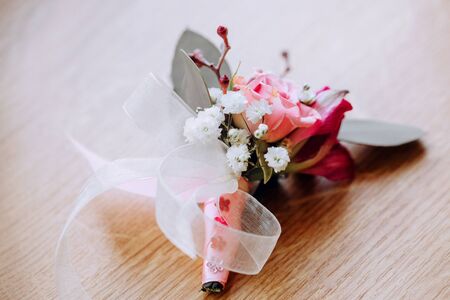 Close up of white and pink rose  boutonniere.の写真素材