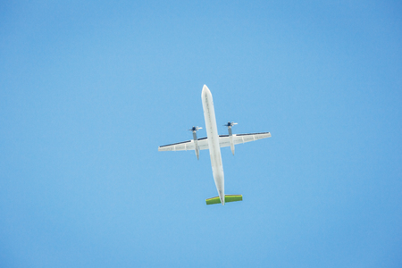 Passenger airplane isolated against the blue sky. Front view.