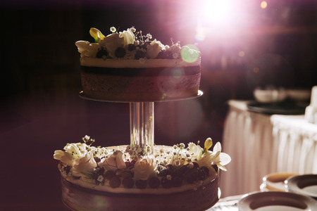 Wedding cake decorated with flowers and berries.の写真素材