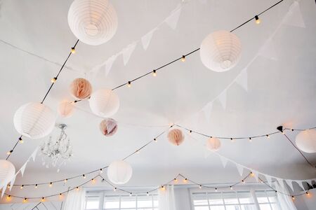 Interior detail - decorated ceilings with lamps and paper balls.