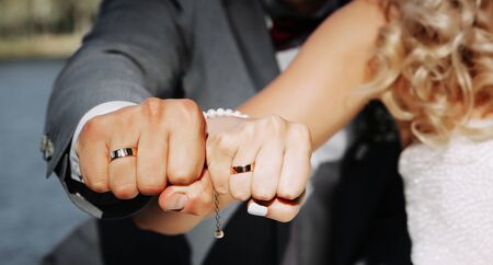 Married couple showing their wedding rings. Close up image.の写真素材