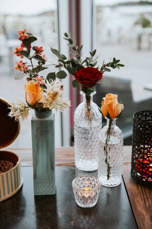 Table decoration with glass bottles and flowers.