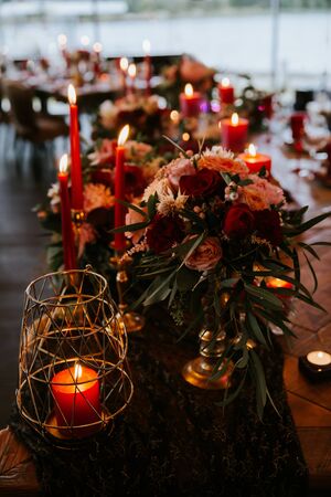 Beautiful, decorated table with flower decorations and red candles.