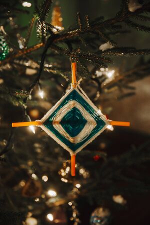 Decorated Christmas tree with star shape handmade decoration. Close up image.