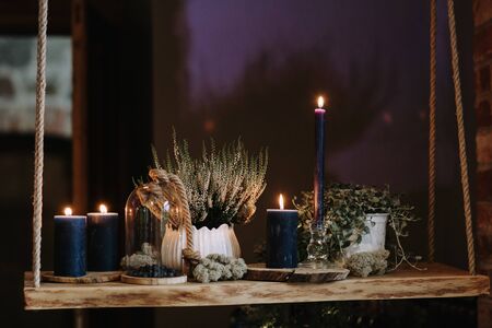 Decoration with burning candles, moss and blueberries.の写真素材
