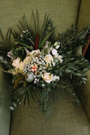 Bouquet of white flowers in the green chair. Wedding bouquet.の写真素材