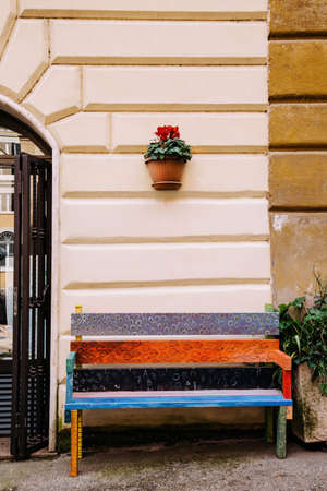 Colorful empty bench on the street to sit and relax.