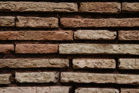 Old red, irregular brick wall texture, close up.の写真素材