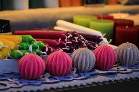 Handmade candles different forms and colors standing and lying on the tableの写真素材