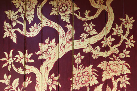 Painting on a wooden board about a bird on a tree branchの写真素材