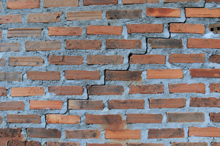 Steps graph on an old broken brick wallの写真素材