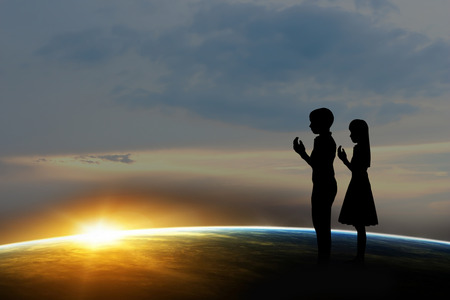 Silhouette  boy and girl  at sunset. Elements of this image furnished by NASAの写真素材
