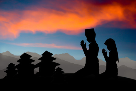 people  praying at the sunset,Pray for the people of Nepalの写真素材