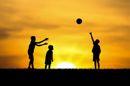 three  brothers  boys play at sunset.の写真素材