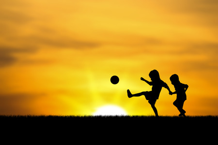 two brothers, boys play at sunset.の写真素材