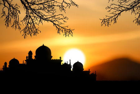 A silhouette of a mosque sunset backgroundの写真素材