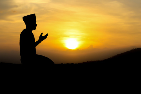 man praying to allah god of Islam on sunset.の写真素材