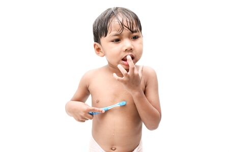 Little boy brushing teeth on white background.の写真素材