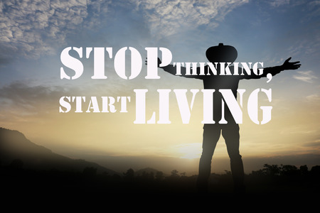 Inspirational quote on blurred a man at sunset background.の写真素材