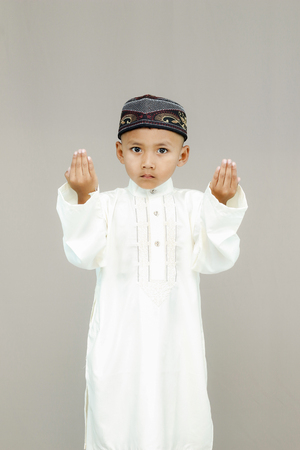 Muslim little cute kid with hat and pray.の写真素材