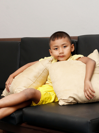 portrait of little asian boy relax in his house.の写真素材