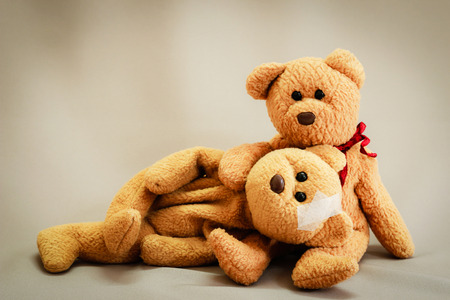 Two teddy bear with bandage on gray background,couples love be care when sickness,health care concept.の写真素材