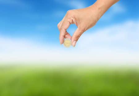 Women hand sent some money  on nature background.