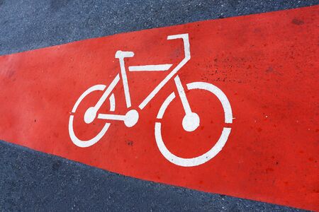 white bicycle sign on red color road .の写真素材