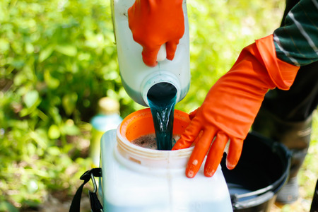 farmer mixing pesticide on the Body spray.
