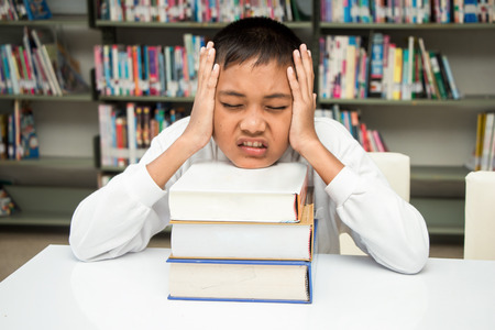 a boy strain with his homework.