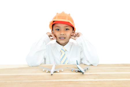 Asian boy in uniform of engineer and toy plane.の写真素材