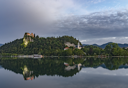 Bled castle at sunrise with mountainの写真素材