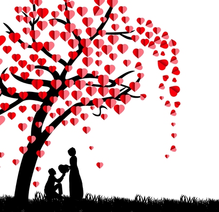 Silhouette of a man presenting a heart on his knee to a beautiful woman under a love tree in the spring seasonの写真素材