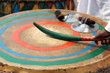 Close-up image of a man playing a drum