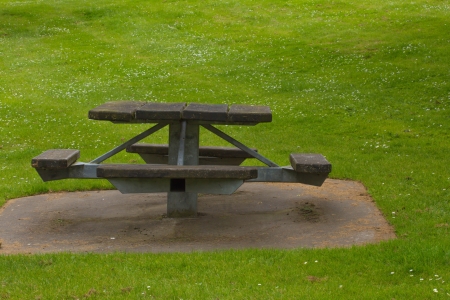 wooden picnic table on the grassの写真素材