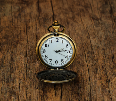 Vintage pocket watch  on wooden background
