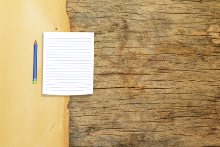 Pencil with  paper note on  old paper ,wood backgroundの写真素材