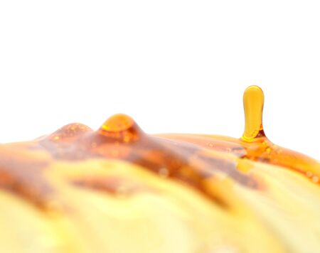 Dipper in Bowl with Honey and Splashの写真素材