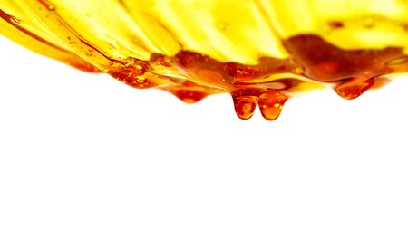 honey flowing on a white backgroundの写真素材