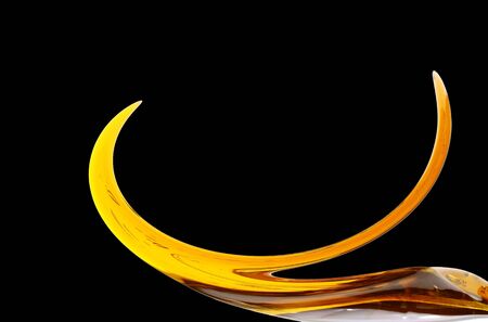 Honey dripping from a wooden honey dipper isolated on white background cutoutの写真素材